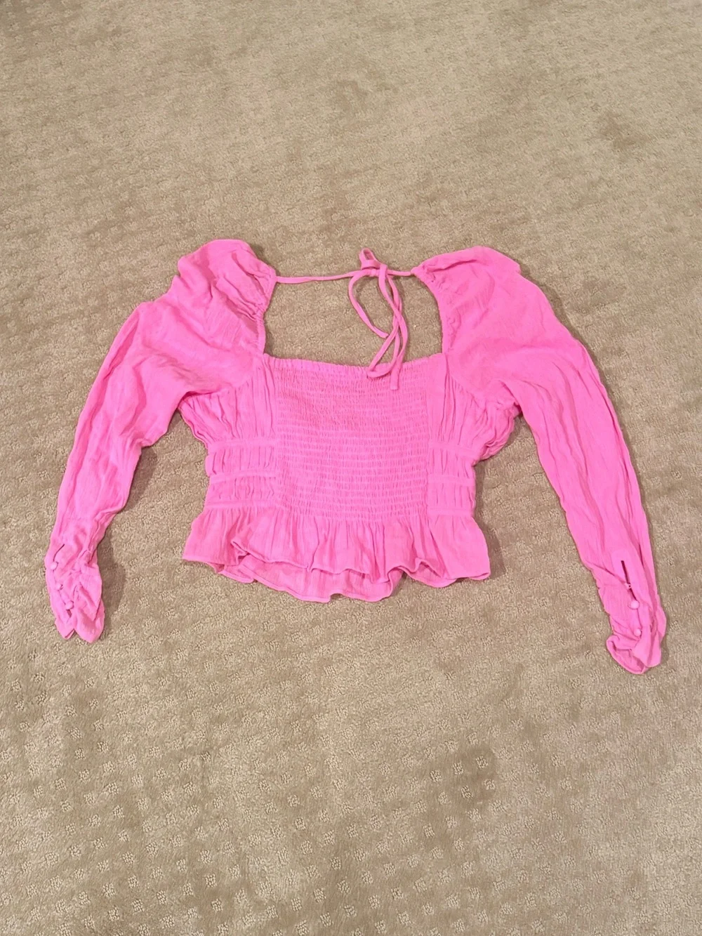 Free People Chloe Top in pink, featuring a smocked bodice and long sleeves